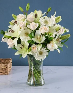 Cream and white flowers in a vase for wedding styling